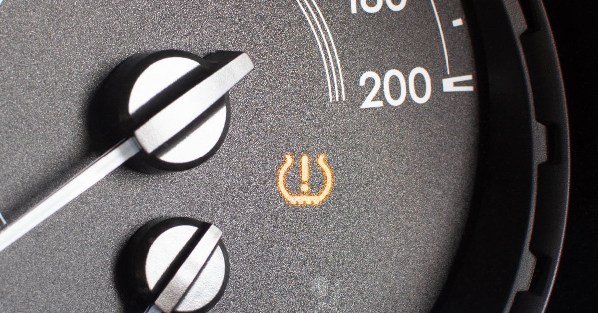 A closeup of the tire pressure indicator light turned on. The light is located on the speedometer of the vehicle.